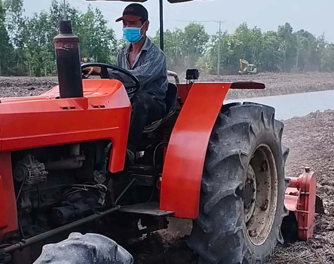 Tractor turning over soil on the raised beds